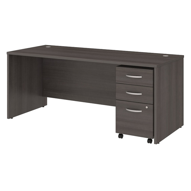 Choose the Studio C Office Desk with Mobile File Cabinet for a durable design that works hard for years and a fresh finish that looks great anywhere. With a thick surface, an extended modesty panel and clean lines, the Office Desk conveys a classic look but adds a contemporary finish to meet the style needs of the modern workspace.  Thermally fused laminate finish fends off scratches and stains to protect the office furniture set.  Office Desk surface offers space to spread out and integrated cable management to conceal computer cords.  Desktop weight capacity tested to support 200 lb.  Mobile File Cabinet locks to secure your letter, legal and A4 size paperwork with a file drawer gliding on smooth full-extension ball-bearing slides.  Mobile File Cabinet includes 2 box drawers with 1 file drawer and rolls wherever you need it.  File drawer weight capacity tested to support 37 lb.  Available in your choice of several contemporary and traditional finishes to fit any work environment.  Brushed Nickel hardware complements the finish.  Commercial quality backed by the Bush Business Furniture 10-Year Manufacturers Warranty. For additional information, please visit: www.bushbusinessfurniture.com/ReturnsExchanges  Bundle includes: 72inW x 30inD Office Desk, 3 Drawer Mobile File Cabinet.  Assembled Dimensions: 71inW x 29 3/8inD x 29 5/6inH  Assembly Required.  Standard Delivery Service. Furniture is delivered unassembled.  Tested to meet ANSI/BIFMA Performance Standards - Manufacturer testing has been conducted on this product to meet specific performance requirements and safety standards set forth by the American National Standards Institute (ANSI) and the Business and Institutional Furniture Manufacturers.  This product is heavy and/or oversized and may need more than one person to handle.