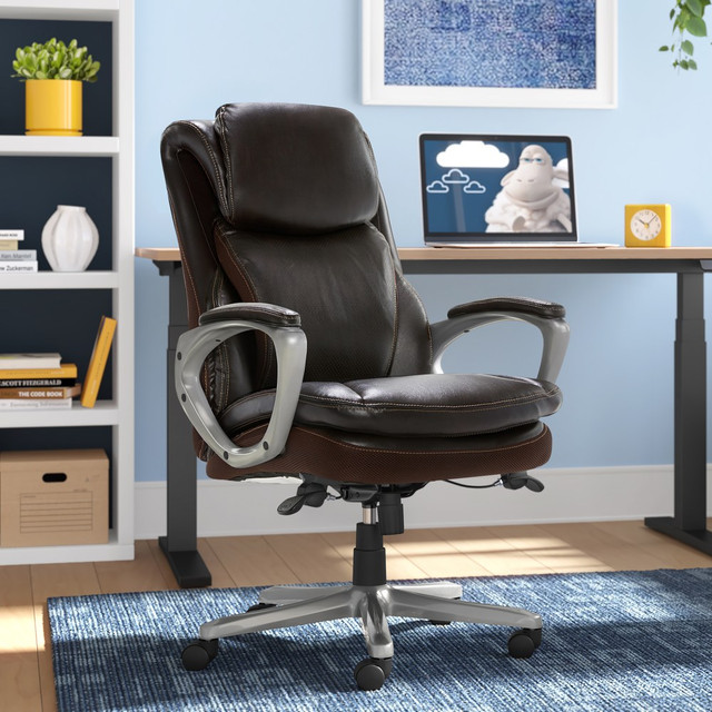 Stay comfortable and productive throughout the day when seated in the Serta Smart Layers Arlington Air Ergonomic Bonded Leather High-Back Executive Office Chair. The contoured lumbar zone helps to minimize pressure on your lower back during long periods of sitting. Integrated casters make it simple to move around your space.  Ergonomic office chair offers comfort throughout the day.  Recommended for professional use 8-10 hours per day.  Weight capacity tested to support 275 lb.  Overall Dimensions: 45-1/2inH x 27-1/2inW x 31-1/4inD.  Plywood frame.  High back.  Smart Layers seat maximizes comfort.  Soft bonded leather upholstery on all seating surfaces.  Broad headrest.  Integrated lumbar support.  Waterfall seat.  Serta office chair boasts height and tilt adjustments.  Padded loop armrests.  Casters offer smooth mobility.  Assembly required.  Ergonomic executive office chair features brown upholstery and a silver frame.  Backed by the manufacturers 10-year limited warranty.  GREENGUARD certified - certified for low chemical emissions: UL.COM/GG - UL 2818. Ranked in two tiers: Certified and Gold.  Tested to meet ANSI/BIFMA Performance Standards - Manufacturer testing has been conducted on this product to meet specific performance requirements and safety standards set forth by the American National Standards Institute (ANSI) and the Business and Institutional Furniture Manufacturers.  Less harsh chemicals - made with fewer harsh chemicals, or safer chemicals than typical alternatives, helping  reduce your use of and exposure to substances that may be more harmful to your health and the environment.