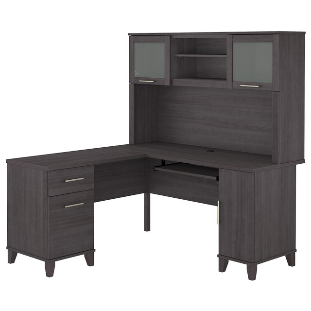 Make a professional statement and maximize your home office capabilities with the Somerset L-Shaped Desk with Hutch. The beautiful and functional corner desk design includes a vertical storage cabinet for binders, manuals or supplies. This expansive workspace allows plenty of room to complete large projects and storage solutions to stay organized.  Bundle includes: 60inW L-Desk and 60inW Hutch.  Constructed of laminate over engineered wood.  Expansive surface provides plenty of room for computer, phone, printer and more.  Pull-out keyboard or laptop tray, pedestals and hutch mount on left or right side for configuration flexibility.  Concealed storage cabinet for a computer tower or supplies with rear wire access.  Box drawer stores office supplies.  File drawer glides on smooth ball-bearing slides and accommodates letter-size documents.  Hutch has closed storage areas with lift-up frosted glass doors.  Open compartments in hutch for books, binders and decorations.  Meets ANSI/SOHO test standards for performance and safety.  Desktop weight tested to support 200 lb.  File drawers weight capacity tested to support 20 lb.  Assembled Dimensions: 59-1/6inW x 59-1/6inD x 64-1/2inH.  Assembly required.  Standard Delivery Service. Furniture is delivered unassembled.  Backed by the Bush Furniture 6-Year Manufacturers Warranty. For additional information, please visit: https://www.bushfurniture.com/ReturnsExchanges.aspx  This product is heavy and/or oversized and may need more than one person to handle.