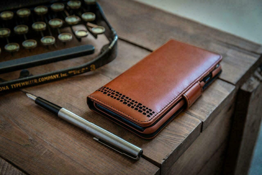 Royale wallet case with phone, cards, and cash inside