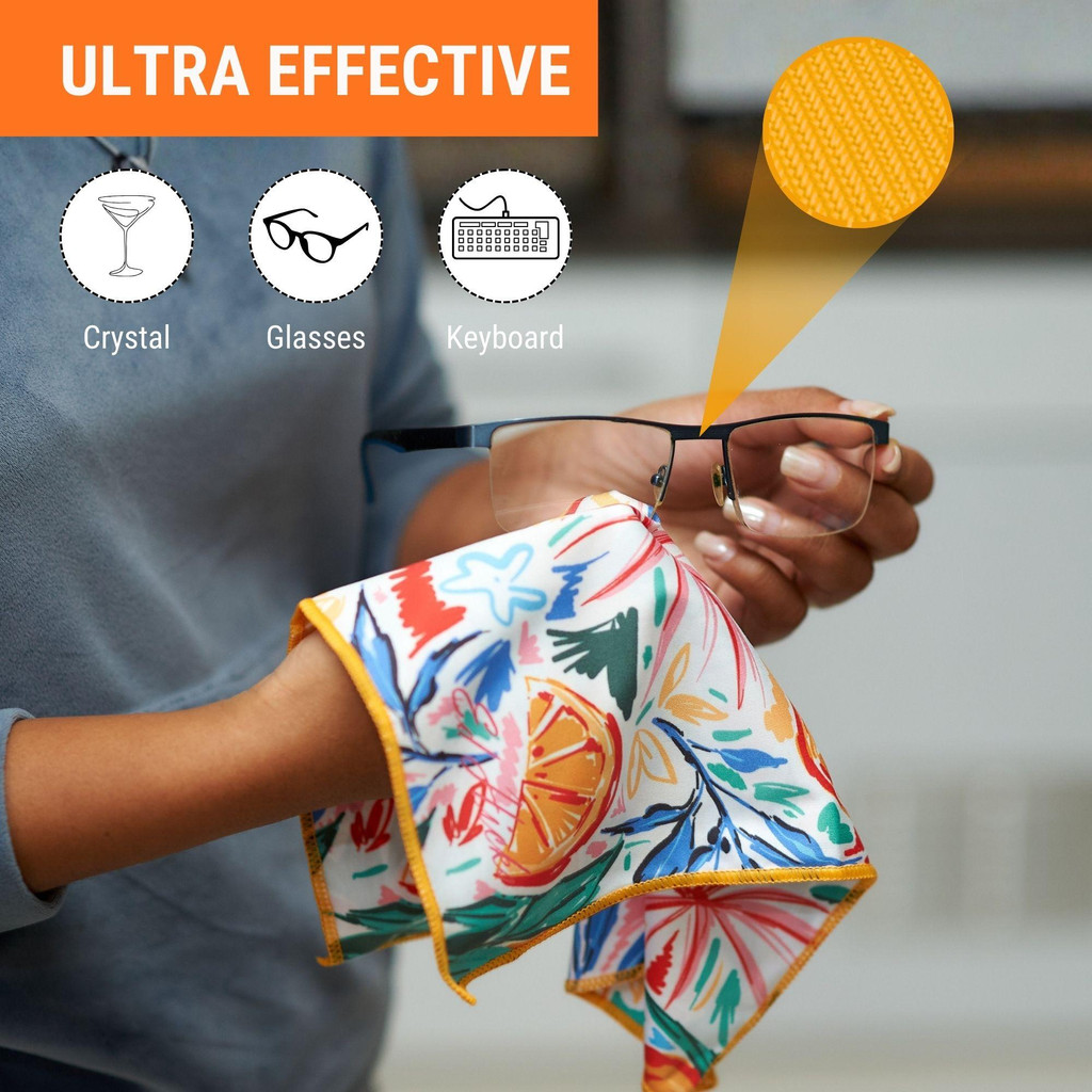 Oranges microfibre cleaning cloth in use on a smooth surface