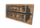 wooden gym sign with barbell
