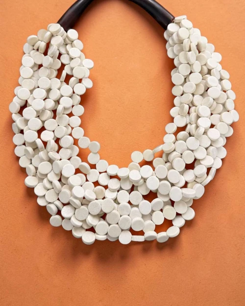 Cultural Elements soft white wood disc necklace with horn closure, 20 inches long, handmade in the Philippines.