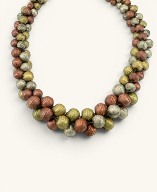 Cultural Elements mixed-tone layered statement necklace with copper, gold, and silver beads. Rustic artisanal finish.
