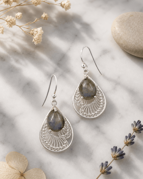 Sterling Silver Labradorite Earrings in Feather Design — earrings, editorial marble lifestyle photo