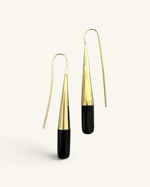 Tosha brass horn threader earrings on white background, front view of gold ribbed cones and black horn cylindrical drops