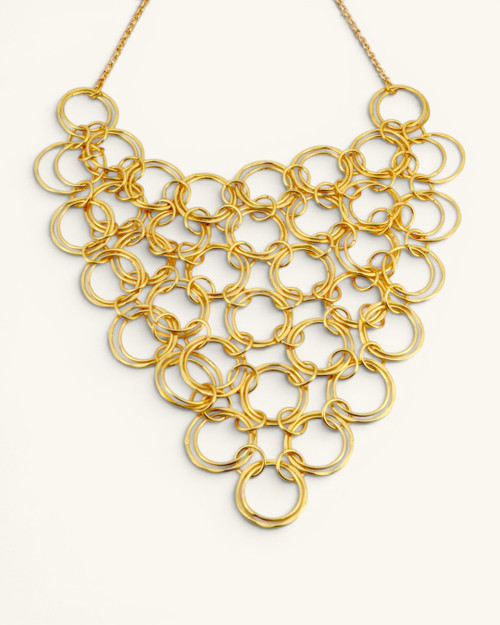 Hand-hammered brass ring bib necklace front view showing interlocked circular rings forming a V-shaped bib panel