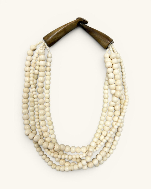 Indian bone bead 5-strand layered necklace with dark horn closure, flat lay front view on white background