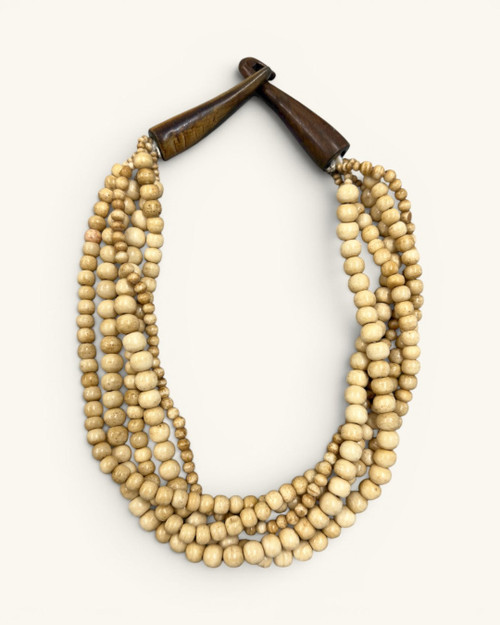 Five-strand Indian bone bead necklace laid flat on white background, horn hook closure fastened at top, front view
