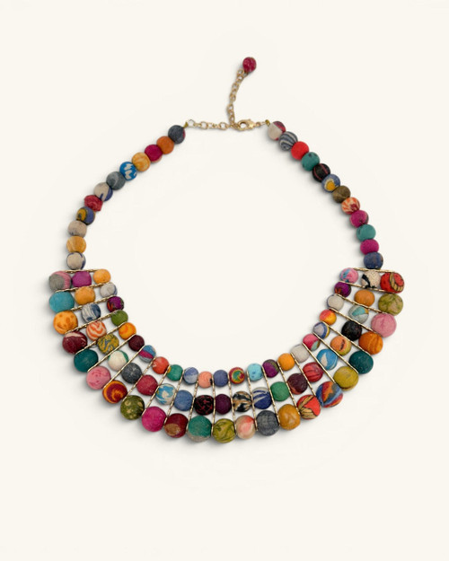 Colorful textile-wrapped bead layered necklace flat lay, front view showing multicolor bib design and gold chain clasp