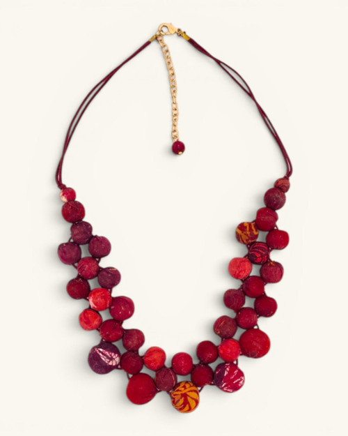 Kantha recycled textile layered bead necklace in red tones, flat lay front view showing two-strand arrangement and gold lobster clasp