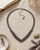 Hill Tribe Silver Floral V-Necklace — necklaces, flatlay linen lifestyle photo