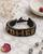Handmade Kenyan beaded power bracelet with multicolor seed beads on white marble surface