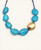 Cultural Elements blue tagua nut necklace with 24K gold plated pod and blue suede cord.