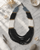 Night Sky Statement Necklace in Black and Grey — necklaces, editorial marble lifestyle photo
