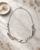Paper Curl Design Metal Necklace — necklaces, editorial marble lifestyle photo