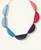 Colorful crescent-shaped Tagua necklace on beige background