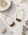 Gold-Plated Brass Hoop Earrings with Black Glass Beads — earrings, editorial marble lifestyle photo