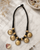 Tribal Inspired Disc Necklace — necklaces, editorial marble lifestyle photo