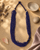 Multi-Strand Blue Glass Bead Necklace with Hand-Painted Ceramic Accents — necklaces, vibey closeup lifestyle photo