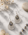 Sterling Silver Labradorite Earrings in Feather Design — earrings, editorial marble lifestyle photo