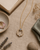 Rainbow Moonstone Circle Gold Plated Necklace — necklaces, flatlay linen lifestyle photo