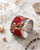 Embroidered lotus flower cuff bracelet displayed on white marble surface