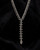 Cultural Elements antique silver tone lariat necklace with ornate Hamsa pendant and repeating links.
