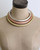Tri-Tone Brass Collar Necklace on a beige dress form mannequin showing three concentric silver, copper, and brass bands at the neck