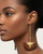 Kenyan brass and wood half-moon drop earrings worn on model in side profile, showing full length of the long brass bar drop