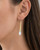 Tosha bone and brass threader drop earring worn on model's ear, close-up side view showing full drop length