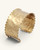 Beaded edge hand-hammered brass cuff bracelet shown from a low side angle, highlighting the open cuff gap and beaded trim