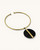 Horn and brass disc choker necklace angled on white background, showing open collar ends and black horn disc with brass bar detail