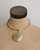 Brass collar choker necklace with Ankole horn disc pendant displayed on a fabric dress form, front view showing fit and scale