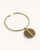 Brass collar choker necklace with Ankole horn disc pendant on white background, angled side view revealing the darker olive reverse face