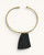 Ankole horn pendant brass choker necklace flat lay, dark trapezoidal horn piece on open brass collar, white background