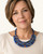 Blue textile-wrapped bead layered necklace worn by a woman in a cream top, showing necklace drape at neckline