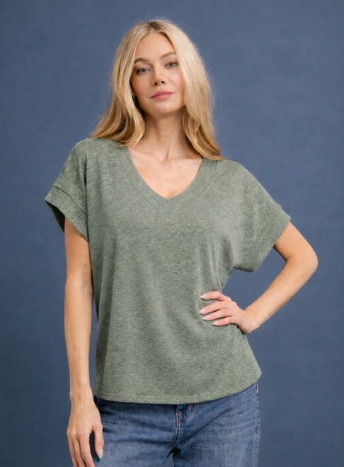 Woman posing in a basic green v-neck tee