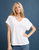 Woman posing in a basic white v-neck tee