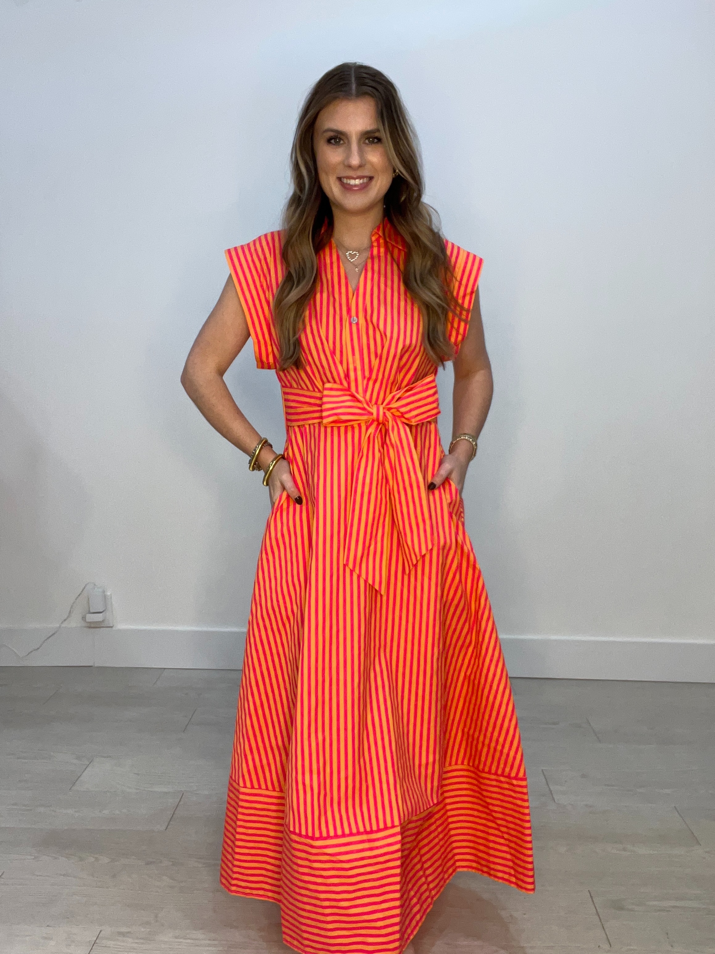 Woman's long short-sleeve orange and white stripped dress with bow