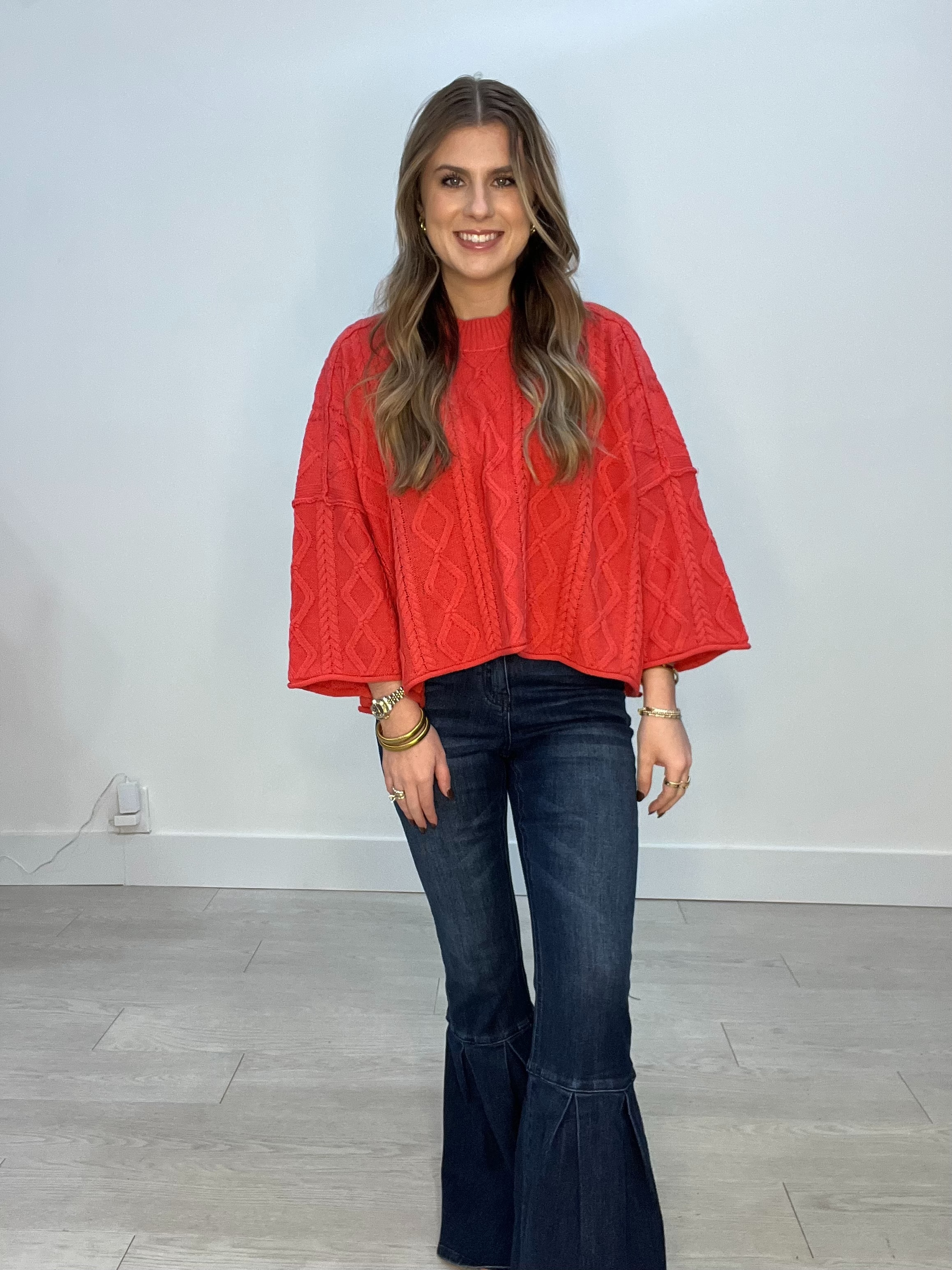Woman's long bell sleeve shirt in red with embedded design