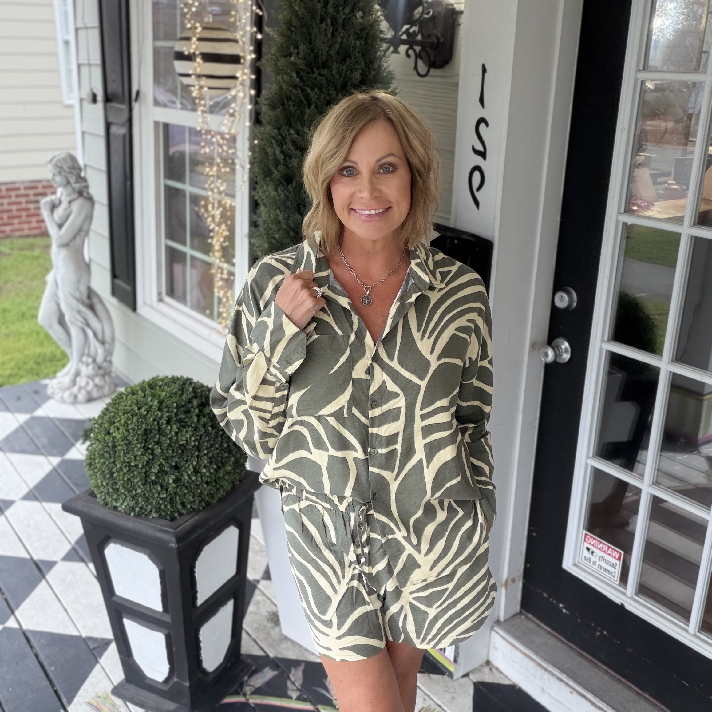 Woman's blue-grey quarterzip sweatshirt with pink illustrative floral design