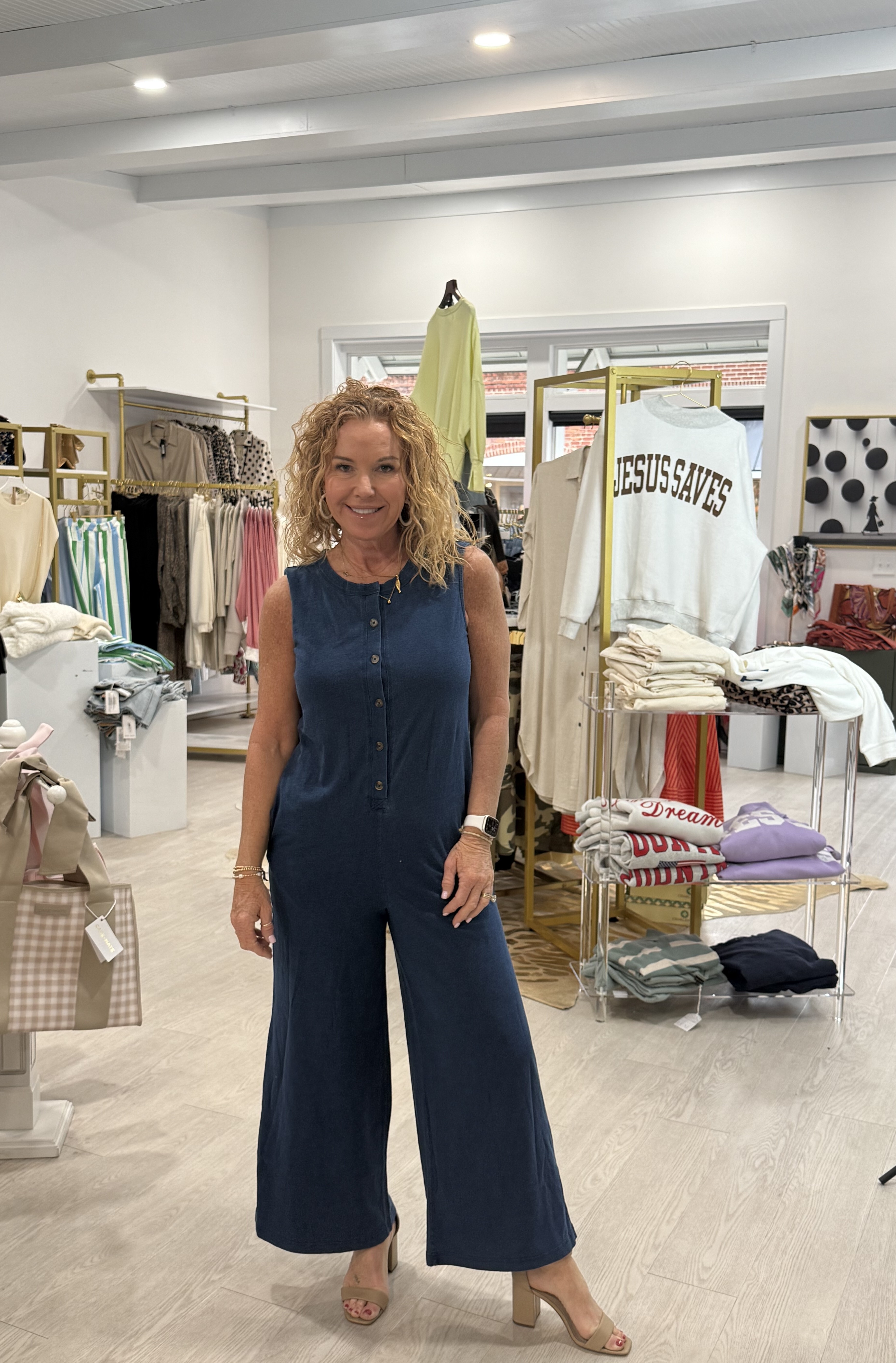 Woman in bright three-quarter sleeve blouse in pink with orange floral designs