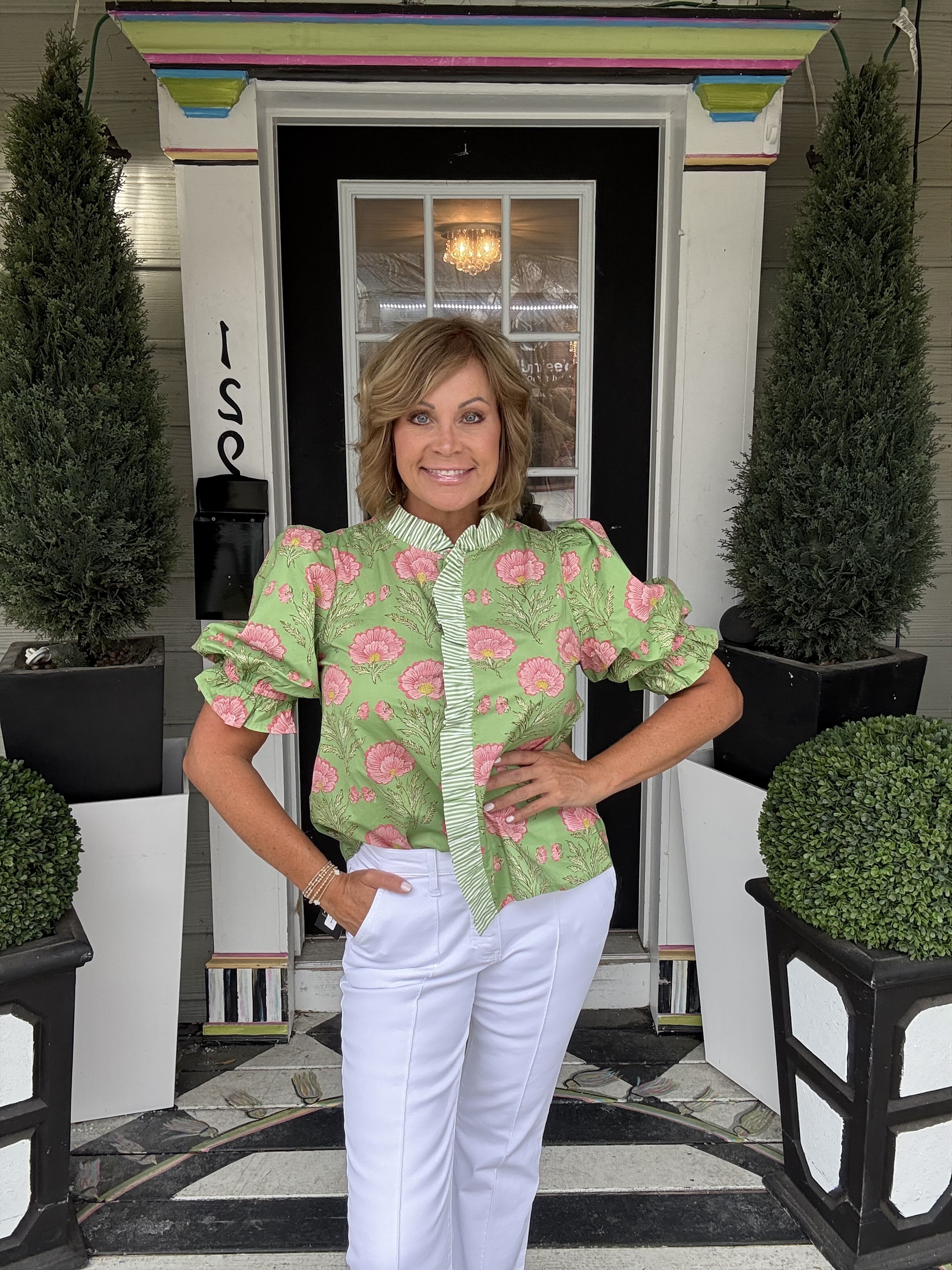 Woman's blue-grey quarterzip sweatshirt with pink illustrative floral design