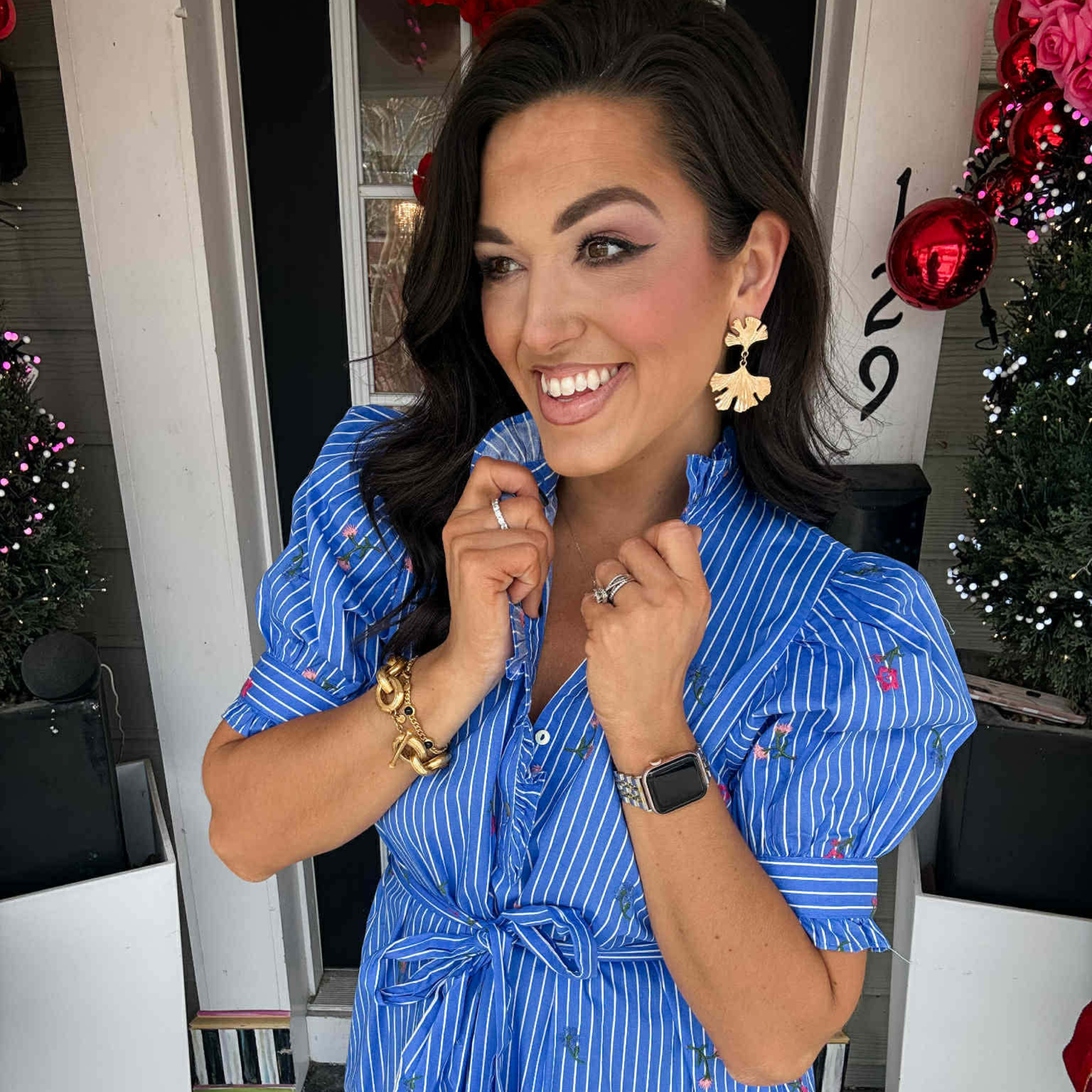 Woman in a blue and white stripped front tie dress with small floral details