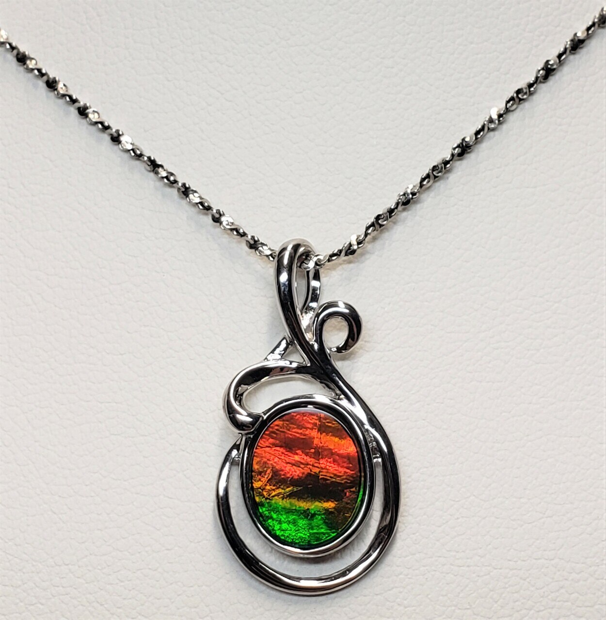 Sterling Silver Wire Ammolite Pendant featuring a 9 X 12 mm Oval Shaped Gemstone