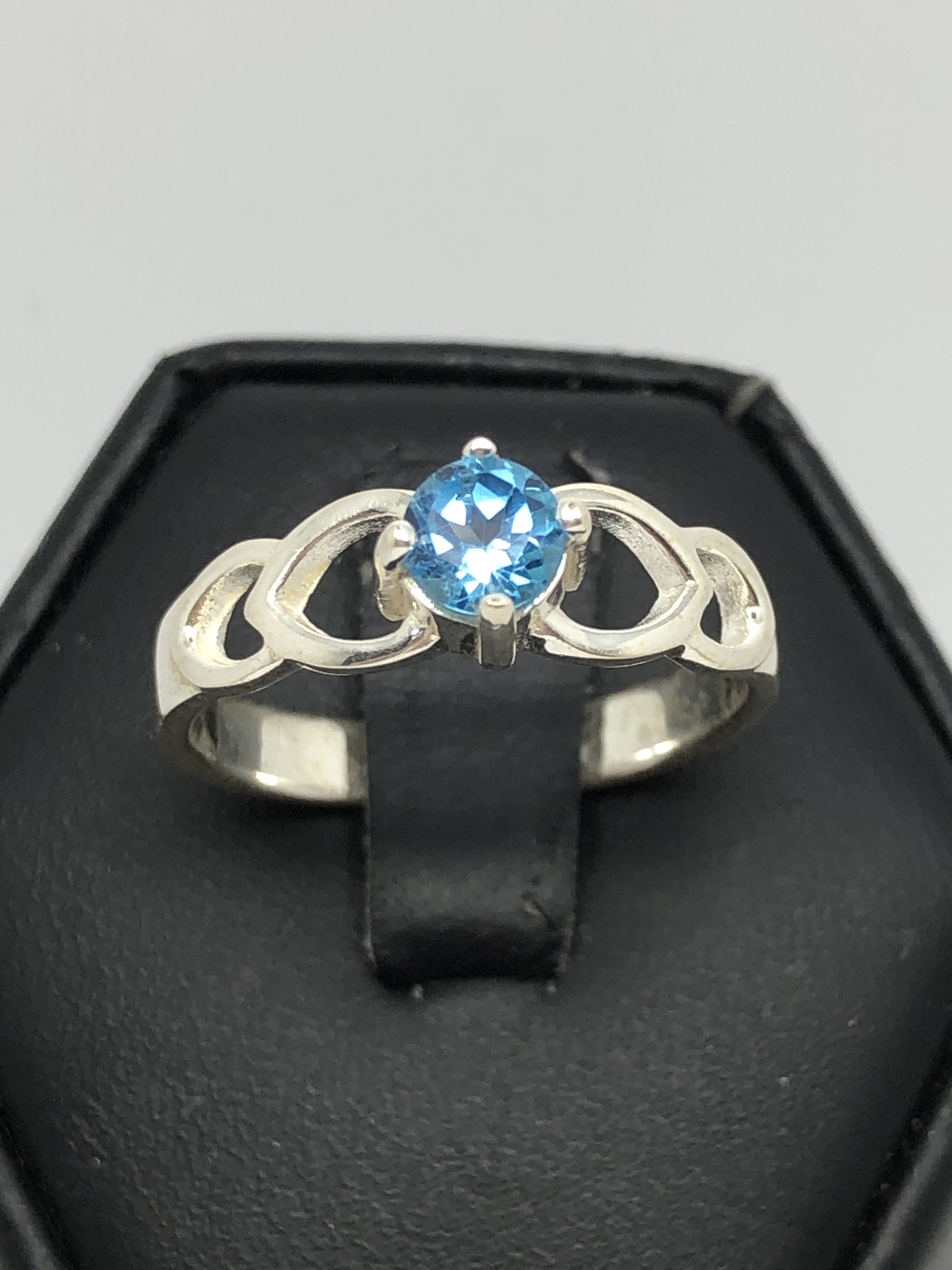 Ladies Sterling Silver ring with blue topaz stone and cutouts in the band. Sz 8 