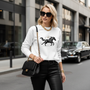 Luxury outfit with white Wild Horse sweatshirt - Premium sportswear styled with designer leather pants and statement accessories for high-end casual look"