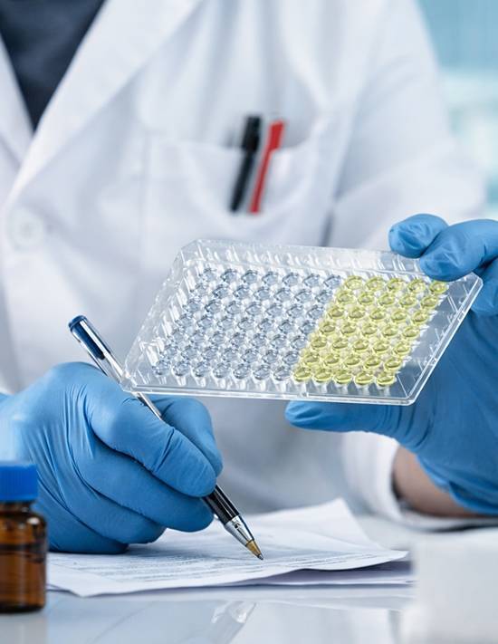 Scientist placing sample under microscope