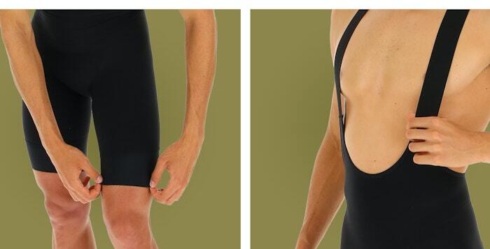 Cyclist demonstrating black bib shorts with elastic straps and leg grippers on a khaki green background